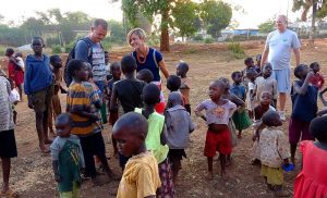 Amy and Chris Compston with the children in Uganda.